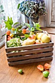 Apples, Pears and Physalis in a wooden box