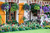 Garden flowers and ornate house, Alsace, France