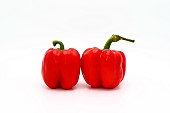 Two red ripe sweet peppers on a light background. Natural produc