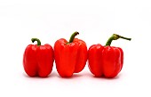 Three red ripe sweet peppers on a light background. Natural prod