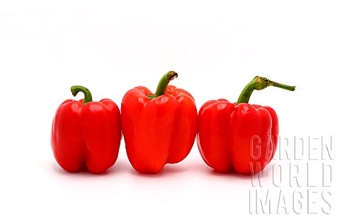 Three_red_ripe_sweet_peppers_on_a_light_background_Natural_prod