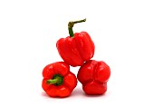 Three red ripe sweet peppers on a light background. Natural product
