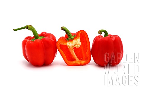 Two_red_ripe_sweet_peppers_and_one_pepper_in_a_cut_on_a_light_background_Natural_product_Natural_col