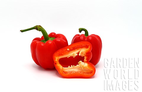 Two_red_ripe_sweet_peppers_and_one_pepper_in_a_cut_on_a_light_background_Natural_product_Natural_col