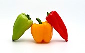 Three sweet peppers of yellow, red and green colors on a light background. Natural product. Natural color. Close-up.