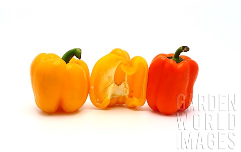 Three_sweet_peppers_in_yellow_and_orange_on_a_light_background_Natural_product_Natural_color_Closeup