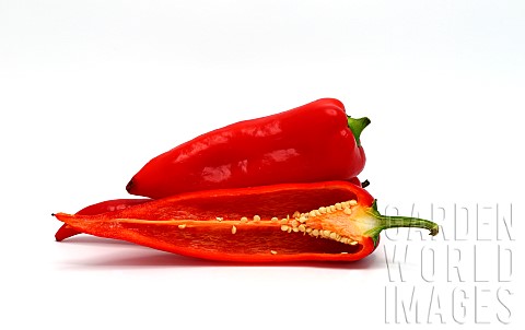 Few_red_ripe_sweet_peppers_and_one_pepper_in_a_cut_on_a_light_background_Natural_product_Natural_col