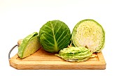 Sliced head of cabbage on a cutting board on a light background. Natural product. Natural color. Close-up.