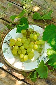 Organic white grapes (Vitis vinifera) on a plate, summer fruits