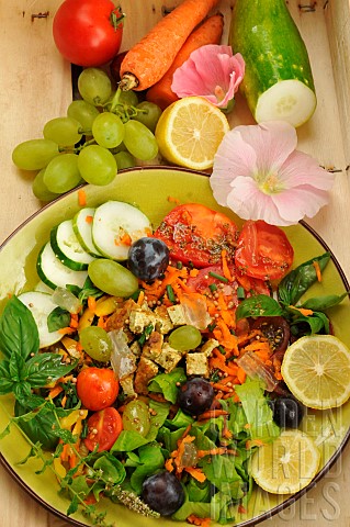 Vegetable_summer_dish_based_on_fruits_vegetables_and_edible_flowers_grapes_cucumber_tomatoes_basil_m