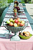 OUTDOOR LIVING; LAID TABLE WITH FRUIT BOWL OF APPLES