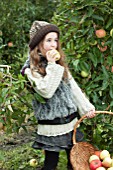 GIRL EATING MALUS DOMESTICA (APPLE) IN AUTUMN