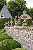 BUXUS SEMPERVIRENS  IN FORMAL PARTERRE GARDEN WITH STONE BALUSTRADE AND ORNAMENTAL CARVINGS AT CHATEAU DE BRECY