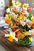 NARCISSUS, TULIPA, RANUNCULUS IN SPRING BOUQUET IN VINTAGE COFFEE TIN