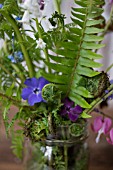 WOODLAND FERNS IN JAR WITH VINCA, BLUEBELLS AND DICENTRA