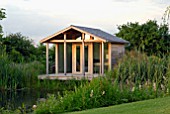 WOODEN SUMMERHOUSE BY POND