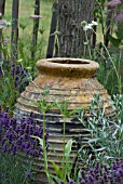 RUSTIC POT SURROUNDED BY DROUGHT RESISTANT PLANTS
