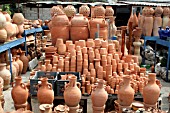 STACKS OF TERRACOTTA POTS ON DISPLAY AT A MARKET STALL IN LEBANON
