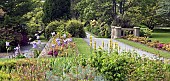 Herbaceous borders, many mature trees, shrubs, spring bulbs, Azaleas, perennials with pathways and lawns in early spring June