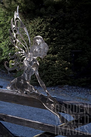Contemporary_hand_crafted_mild_or_stainless_steel_sculpture_of_Angel_sitting_on_gate
