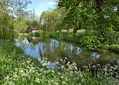 Boathouse on the Weeping Willow lined River Sow running though the parklands in springtime at Shugborough park and landscaped gardens in May Great Haywood Staffordshire
