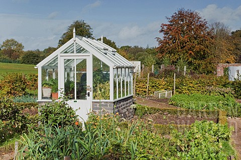 Old_style_small_white_wooden_greenhouse