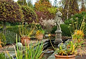 Canal garden with terra cotta pots and statuary