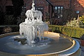 Frozen ornate water fountain and statue