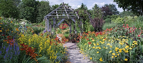 Garden_Room_called_the_Lanhydrock_Garden_with_central_oak_pergola_borders_of_hot_coloured_herbaceous