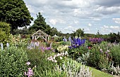 Borders of herbaceous perennials, grass paths, mature trees