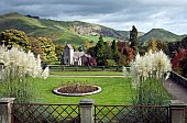 Views in autumn across Illam Hall church and gardens to the hills of Dovedale in Derbyshire