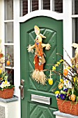 HOUSE ENTRANCE WITH EASTER DECORATION AND SPRING FLOWERS