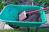 PLASTIC WHEELBARROW WITH COMPOST AND SPADE